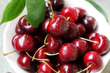 juicy ripe sweet cherries in a cup. close-up, blurred focus. copy space