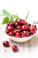 juicy ripe sweet cherries in a cup. close-up, blurred focus. copy space