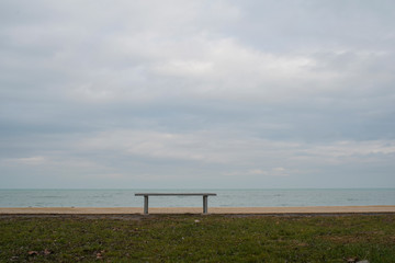 An iron bench overlooking the cloudy rainy Lake Balaton.