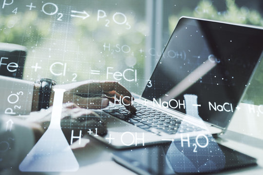 Double exposure of creative chemistry concept with hands typing on laptop on background, research and development concept