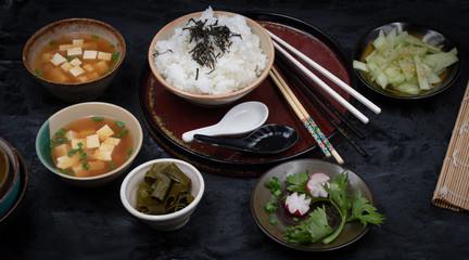 Vegan Japanese meal consisting of tofu miso soup, rice and cucumber salad