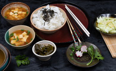 Vegan Japanese meal consisting of tofu miso soup, rice and cucumber salad