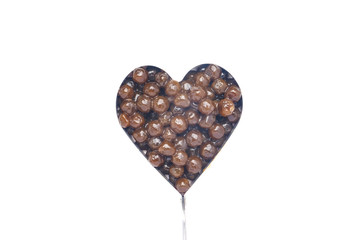Tapioca ball or pearl tea in heart shape mold on isolated white background.