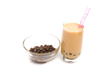 Homemade pearl milk tea with a bowl of tapioca ball insight on white background.