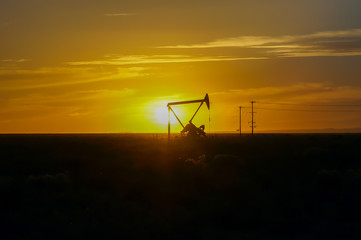 Silhouette Oil pumps at oil field with sunset sky background