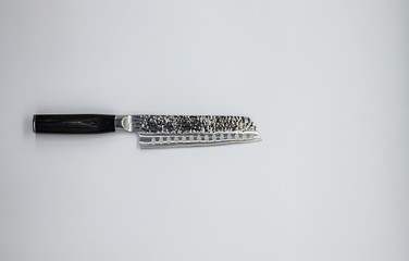 Japanese damascus kitchen knife on the white backround