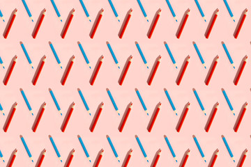 Pattern of colorful pencils. Red and blue pencils on pink background. Back to school, education and learning concept. Minimalist isometric concept.
