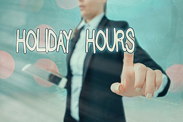 Writing note showing Holiday Hours. Business concept for employee receives twice their normal pay...