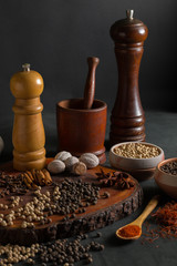 Still life with different kind of spices on a black background.