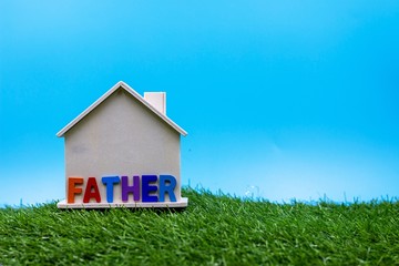 Happy Father's Day with word on house on green grass
