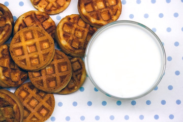 waffles with milk on a white-blue background copy space