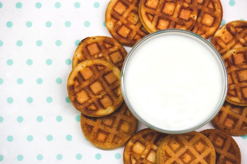 waffles with milk on a white-turquoise background copy space