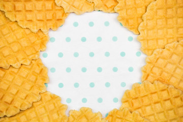 baked round waffles on a white turquoise background copy space