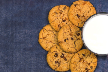 Cookies with milk on a blue background copy space
