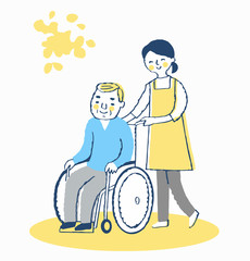 車椅子のシニア男性と女性介護スタッフ
