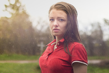 portrait of young beautiful mysterious lady, wet woman, under the summer rain. Girl Fills Her Face With Raindrops.