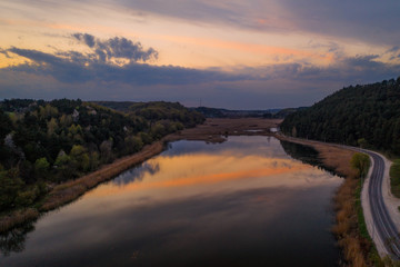 Evening (sunset) landscape with lake, spring and forest in Vereshchytsia, Lviv district. May 2020. Aerial drone view.