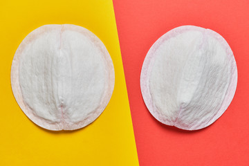 Women pad for bra on a yellow and red background. © gesrey