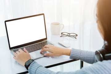 Fototapeta premium Work from home, Back of Asian young businesswoman video conference call or facetime meeting online on front laptop computer quarantines disease coronavirus or COVID-19 at home office, Focus on laptop