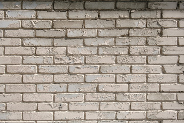 Obraz premium Wall of white brick with peeling off paint outdoors. Background.