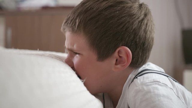 childrens stress, nervous crying boy suffers and suffers from nervous breakdown, disobedience and punishment, is hysterical in room and beats sofa with hands, poor relationship with parents