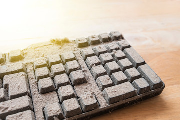 Dusty keyboard extreme on wood table. dusty computer keyboard.