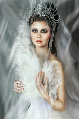 close up portrait of beautiful girl. professional white winter makeup. snow queen with beautiful crown. snow castle