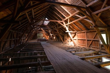 Interior of large old timber frame barn in Germany during renovation, upper floor wide angle shot