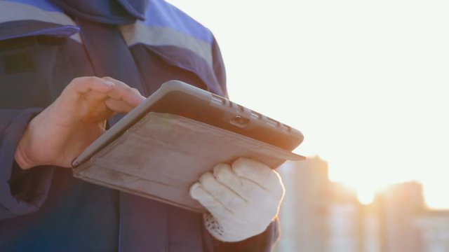 Tablet computer in workers arms