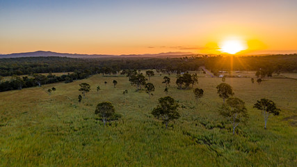 Fototapeta na wymiar Sunset over farmland in Calliope, Queensland, Australia 