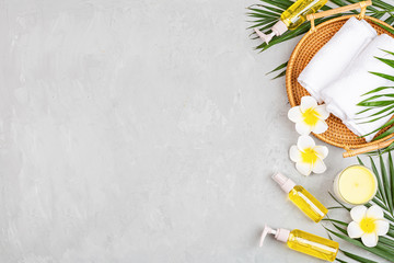Spa massage Aromatherapy body care background. Spa herbal balls, cosmetics, towel and tropical leaves on gray concrete table. Top view, flat lay, overhead, copy space. Beauty and health care concept
