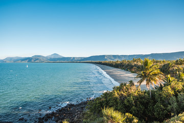 Aerial view on beach surrounded by mountains and trees in Australia