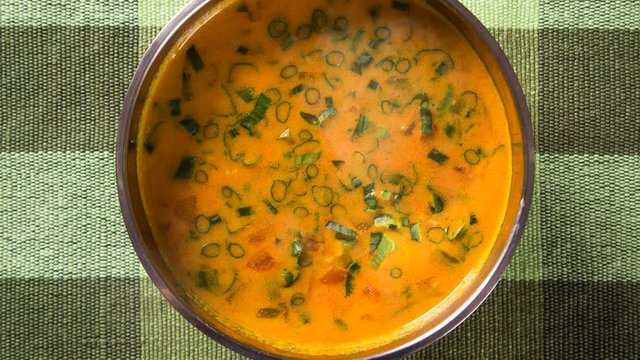 Sururu soup inside a metal bowl. Brazilian dish with smoke.