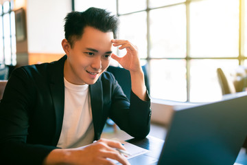 young Business man  Working On Laptop In Coffee Shop