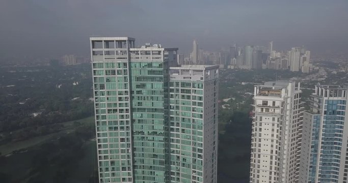 Ungraded, Ascending aerial flight over high rise building revealing metropolitan city's skyline. Drone, 4K.