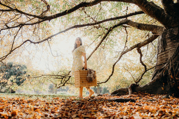 Happy Woman Life Style, beautiful asian girl on the nature picnic with fruits. Relaxing asian woman in Nature. Autumn landscape background. Active Outdoor Relax in Nature.