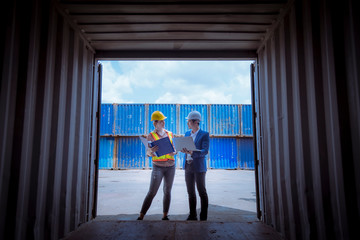 A Manager and dock worker under discussion about dock container shipping warehouse document,they...