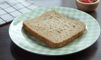 whole wheat bread in  plate on  wooden table for breakfast meal