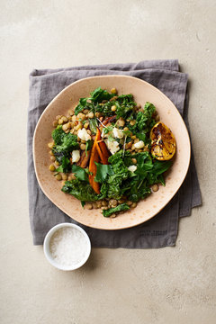 Top view image of vegetarian lunch, lentil salad with honey-roasted carrots, kale and goat cheese