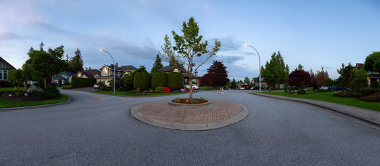 Residential Suburban Neighborhood in the City during a vibrant spring sunset. Taken in Fraser Heights, Surrey, Vancouver, BC, Canada. Panorama, Wide Angle © edb3_16