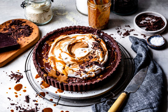 Chocolate caramel tart with whipped coconut cream, caramel and chocolate shavings