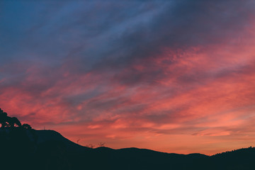 pink sunset sky with beautiful clouds over the hills of Tasmania