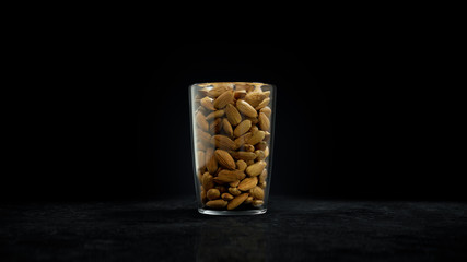 Almonds in a Glass Cup on wood table. Nuts Filling a Small Glass Mug. Front View