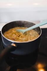 plant-based food,  vegan one pot pesto pasta with onions and capsicums cooking in pot