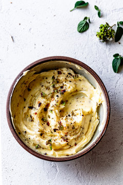 Garlic butter with herbs in a bowl.