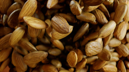 Almonds Explode Towards the Camera and Hang Floating in Air.