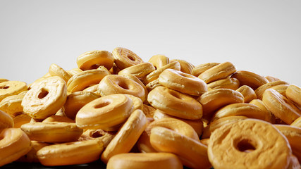 Close-up on Stacked Plain Donuts. Pile of Sweet Doughnuts with Icing on White Background.