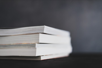 stack of books shot from eye level with shallow depth of field.