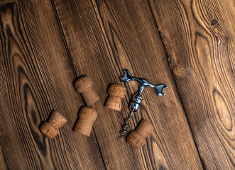 corks and corkscrew on an old wooden table