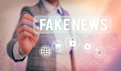 Writing note showing Fake News. Business concept for false information publish under the guise of...